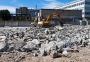 digger demolishing houses for reconstruction