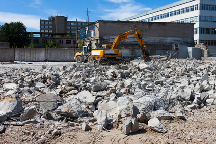 digger demolishing houses for reconstruction